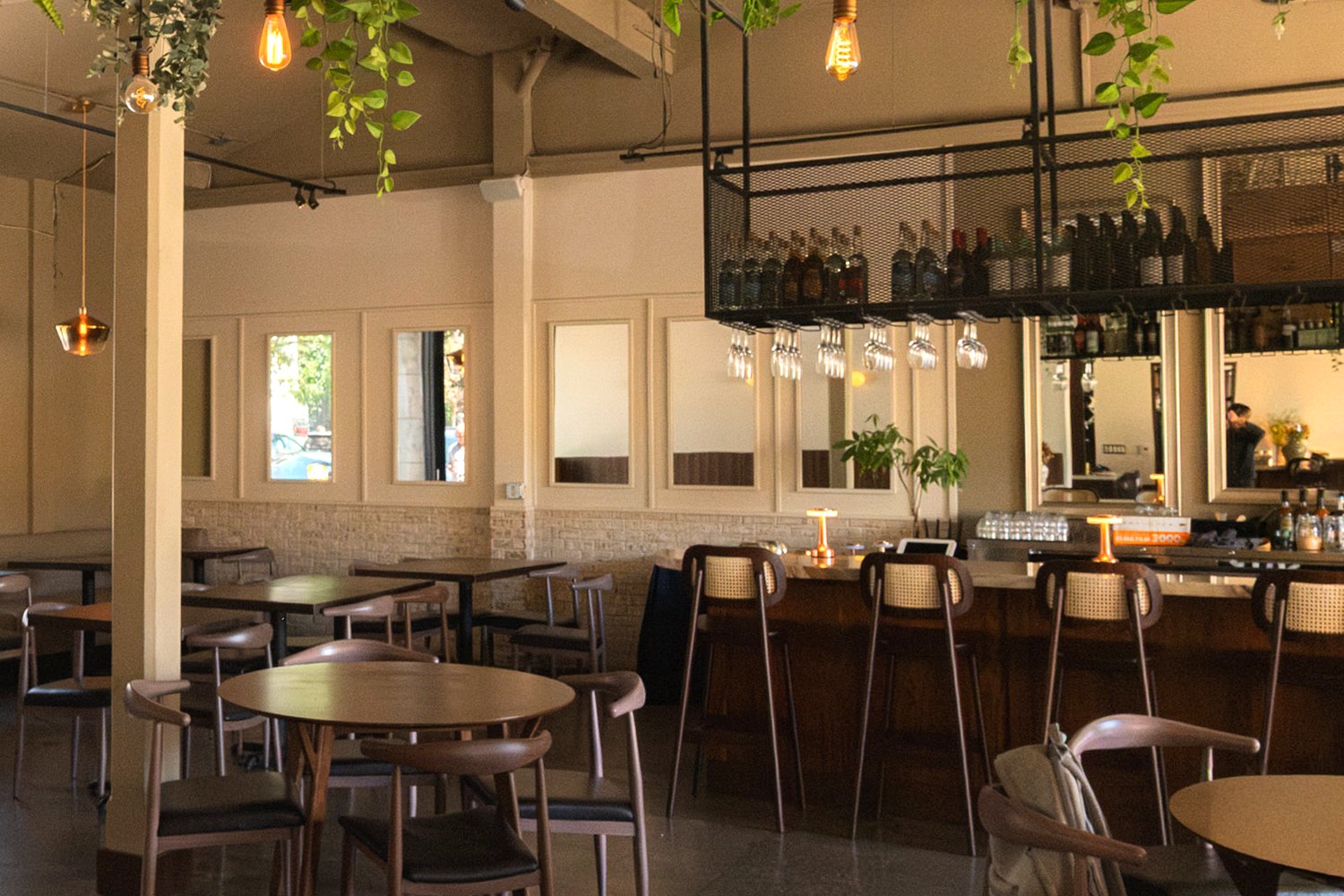 Inside Danbi: the walnut banquette beneath warm brass light
