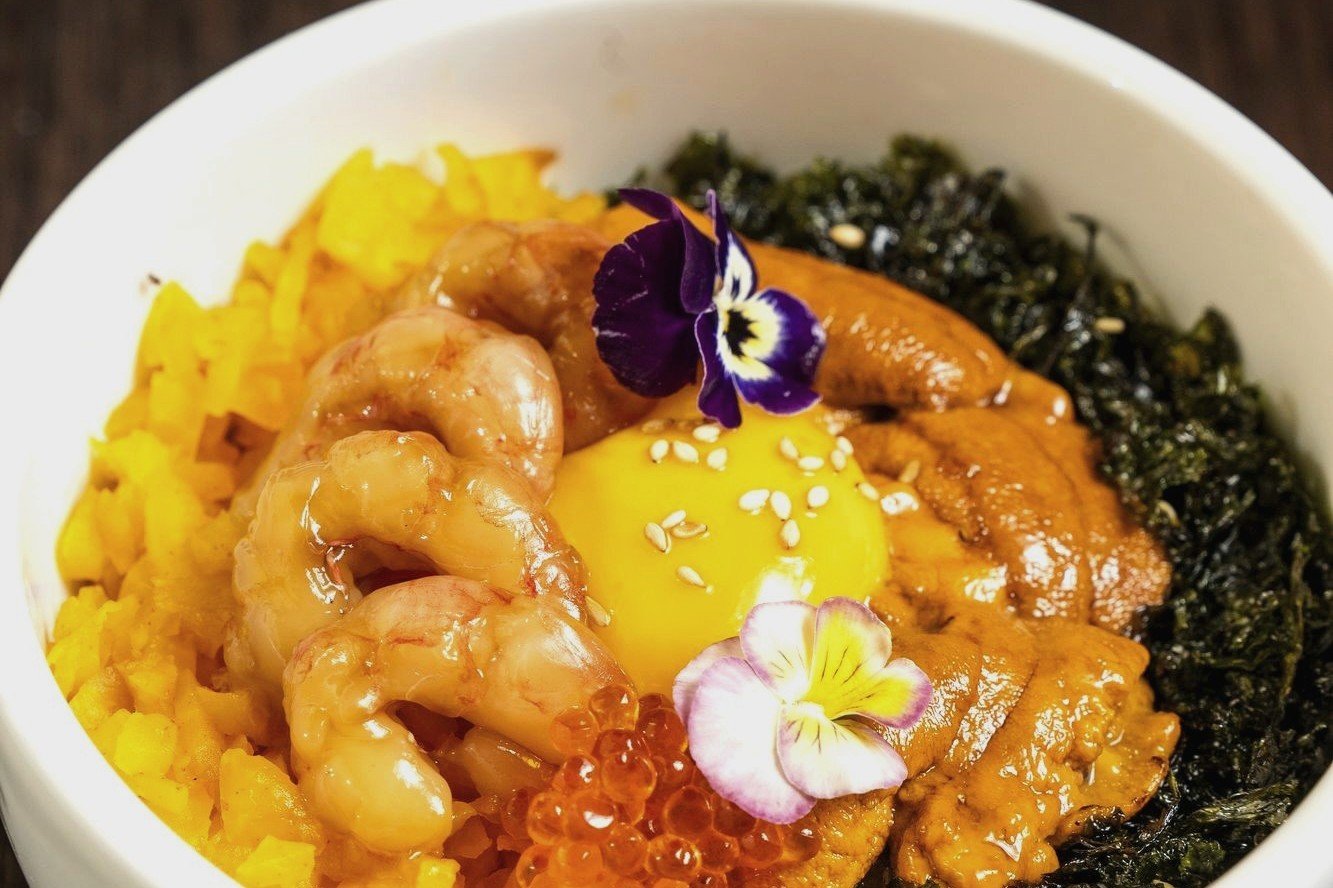 Uni bibimbap: cold uni, sweet shrimp, runny yolk and trout roe over warm rice