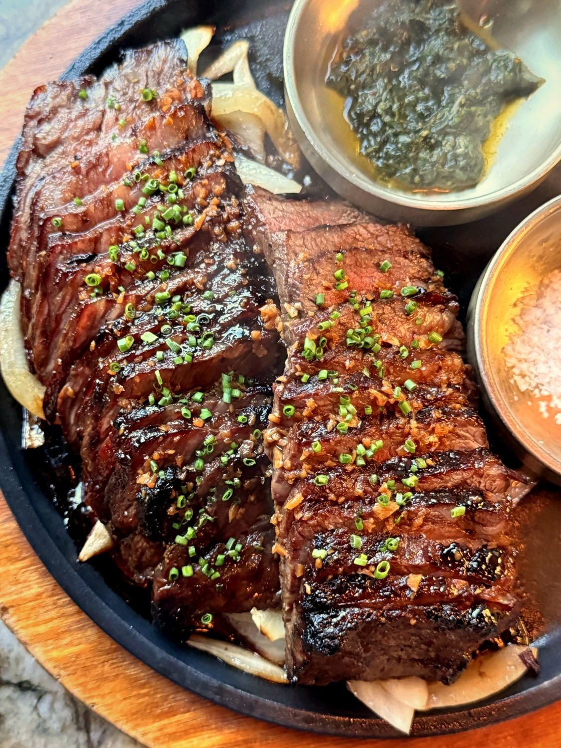 Zabuton wagyu, charcoal-grilled and sliced, with herb sauce